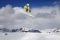 A jumping skier in the mountains. Mountain ski, winter extreme sport.