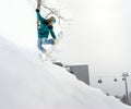 Jumping snowboarder in mountains Royalty Free Stock Photo