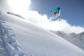 A jumping snowboarder in the mountains. Snowboarding, winter extreme sport.