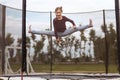 Jumping on Trampoline. Little girl jumps on trampoline. Happy funny childhood