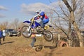 Jumping upwards rider up on a motorcycle MX Royalty Free Stock Photo