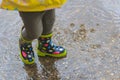 Jumping water puddles with spotted colorful boots