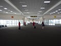 28 jun 20, Donmueng Airport, Bangkok, Thailand. Group of cabin crew in red uniform waking with trolley bag in empty terminal. Airp Royalty Free Stock Photo