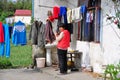 Jun Le, China: Woman Hanging Laundry