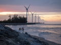 Wind mill park in a beach landscape sunset.