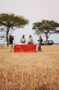 Safari outdoor picnic with beverage bar in Savanna field of Serengeti forest