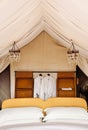 Luxury Safari tent camp bedroom interior in Serengeti Savanna forest - Glamping travel in Africa wild forest