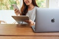 Jun 16th 2020 : A woman holding and using Iphone 11 Pro Max smart phone and Apple New Ipad Pro 2020 tablet pc with Apple Royalty Free Stock Photo