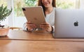 Jun 16th 2020 : A woman using Apple New Ipad Pro 2020 tablet pc with Apple MacBook Pro laptop computer on wooden table Royalty Free Stock Photo