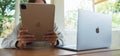 Jun 16th 2020 : A woman using Apple New Ipad Pro 2020 tablet pc with Apple MacBook Pro laptop computer on wooden table Royalty Free Stock Photo