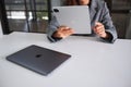 Jun 27th 2020 : A woman using Apple New Ipad Pro 2020 tablet pc with Apple MacBook Pro laptop computer on wooden table Royalty Free Stock Photo