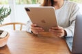 Jun 16th 2020 : A woman using Apple New Ipad Pro 2020 tablet pc with Apple MacBook Pro laptop computer on wooden table Royalty Free Stock Photo