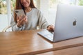 Jun 16th 2020 : A woman using Iphone 11 Pro Max smart phone and Apple MacBook Pro laptop computer , Chiang mai