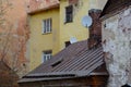 Junction of time in Vyborg. The roof of an old residential medieval house built in the 16th century with modern satellite dish, Royalty Free Stock Photo