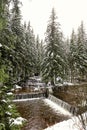 Junction of two mountain rivers with weir in the winter with light snow Royalty Free Stock Photo