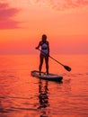 June 25, 2021. Anapa, Russia. Silhouette of woman paddle on stand up paddle board at quiet sea with sunset. Woman on Red Paddle