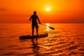 June 21, 2021. Antalya, Turkey. Man on stand up paddle board at ocean with bright sunset. Vacation on sup board in sea Royalty Free Stock Photo