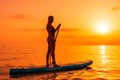 June 21, 2021. Antalya, Turkey. Silhouette of woman on stand up paddle board at sea with sunset or sunrise colors. Woman posing on Royalty Free Stock Photo