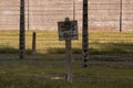 June 15 2022: Auschwitz, Poland. warning Sign board about Electrified fence in Concentration Camp. There More than three