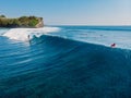 1 June 2021. Bali, Indonesia. Aerial view with surfing on glassy wave. Blue wave and surfers in ocean