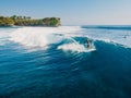 1 June 2021. Bali, Indonesia. Aerial view with surfing on glassy wave. Blue wave and surfers in ocean
