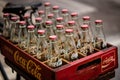 2020 June Bangkok Thailand. Vintage Coca-Cola clear glass bottle in Red Plastic Box carry on bicycle