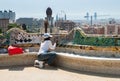 Professional restorer working at colorful ceramic bench in Parc Guell. Barcelona. Spain