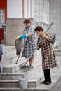 June 22, 2015 - Barnaul, Russia. Elderly cleaning women wash the steps of the building with rags