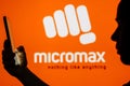 June 13, 2023, Brazil. Micromax Informatics logo is seen in the background of a silhouetted woman