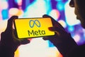 June 1, 2022, Brazil. In this photo illustration, a silhouetted woman holds a smartphone with the Meta Platforms, Inc. logo