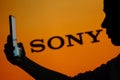June 13, 2023, Brazil. Sony logo is seen in the background of a silhouetted woman holding a mobile