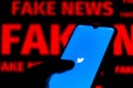 June 15, 2020, Brazil. In this photo illustration the Twitter logo is displayed on a smartphone and red alerting word FAKE NEWS on