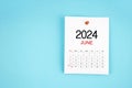 June 2024 calendar page with push pin on blue background Royalty Free Stock Photo