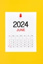 June 2024 calendar page with push pin on yellow background