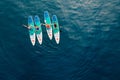 June 21, 2022. Dalaman, Turkey. Aerial drone view of female group on stand up paddle board at blue sea. Ladies on Red paddle sup