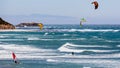 June 6, 2019 Davenport / CA / USA - People kite and wind surfing in the Pacific Ocean, near Santa Cruz, on a sunny and warm day