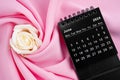 June 2024 desk calendar black color and rose on pink textile Royalty Free Stock Photo