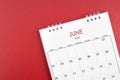 June 2024 desk calendar on red background