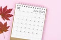 The June 2023 desk calendar for 2023 year with autumn maple leaf on pink color background