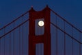 Full moon shining through the north tower of the Golden Gate Bridge in San Francisco, California. Royalty Free Stock Photo