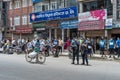 Man walks with a bicycle loaded with a bag along police and protesters against corruption