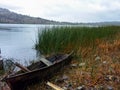 June Lake - Old abandoned wooden boat floating at the lakeshore in California