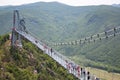 Tourists walk on glass bridge 5D