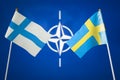 June 29 Madrid Spain, flags of Finland and Sweden on the background to the NATO symbol, concept, Summit of the Alliance