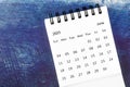 The June Monthly desk calendar for 2023 year on old blue wooden background