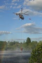 2021 June 4 Moscow region Podolsk - Helicopter refill bucket in lake for fire fighter Royalty Free Stock Photo