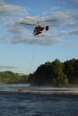 2021 June 4 Moscow region Podolsk - Helicopter refill bucket in lake for fire fighter Royalty Free Stock Photo