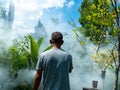 Man Sprays White Smoke to Repel Mosquito Bites