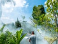 Man Sprays White Smoke to Repel Mosquito Bites