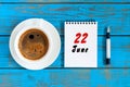 June 22nd. Image of june 22 , daily calendar on blue background with morning coffee cup. Summer day, Top view